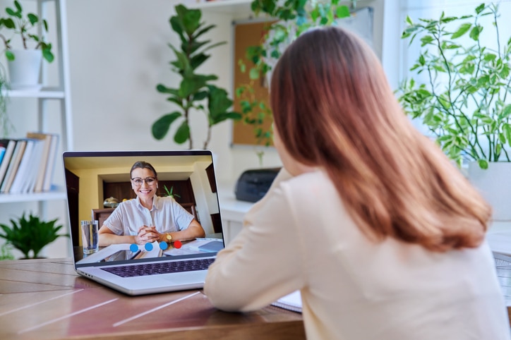 Young female on online therapy with psychologist, psychotherapist Young female on online therapy with psychologist psychotherapist, using video conference call on laptop. Technology, health care, mental support social services, psychology psychotherapy youth concept