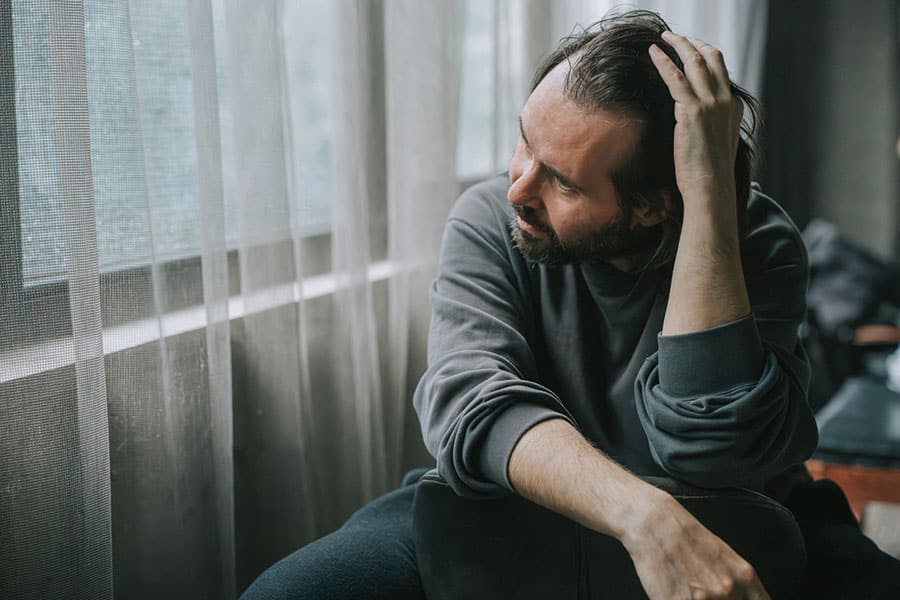 Man depressed by window